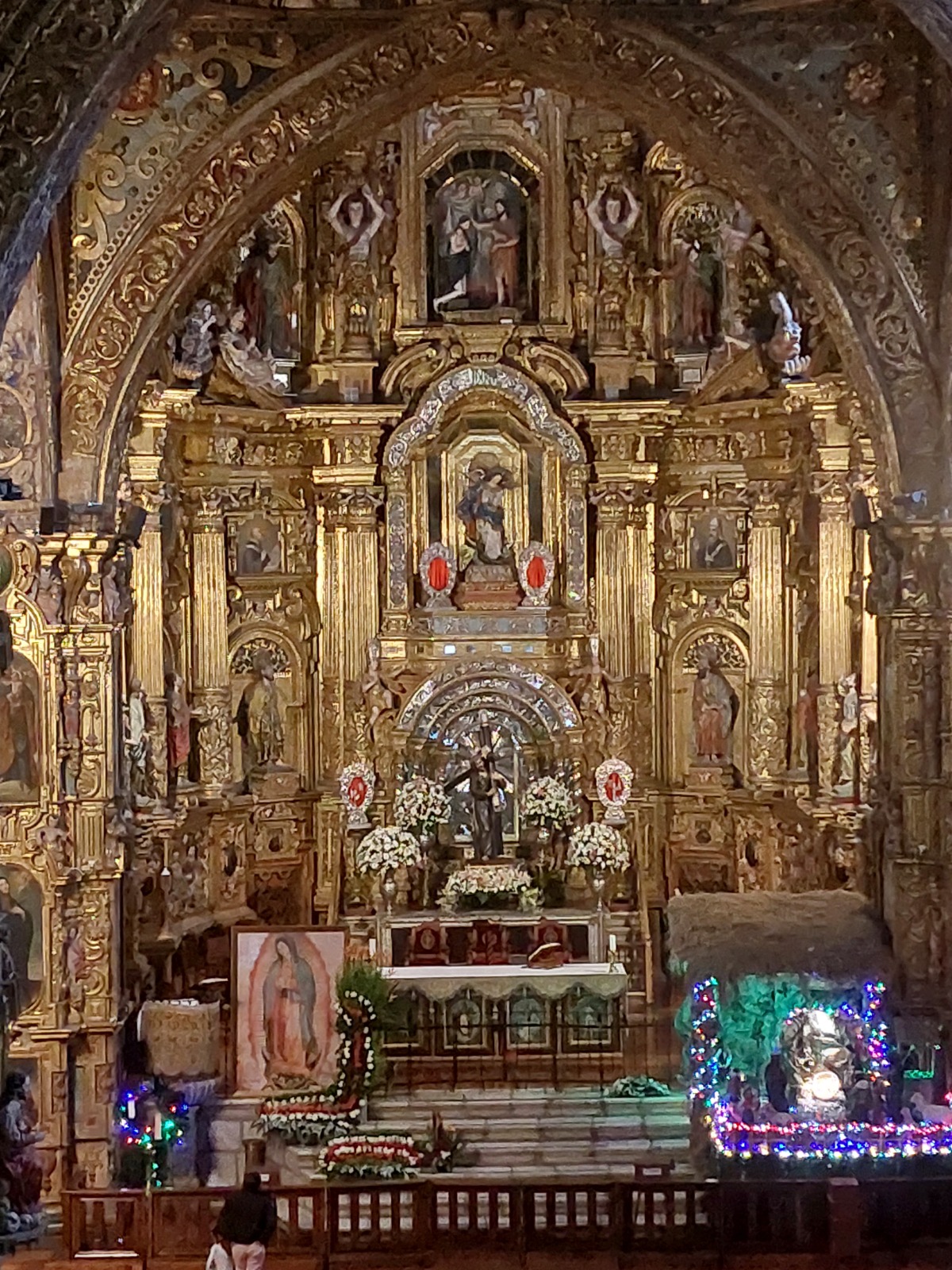 Golden altar inside La Compania Church in Quito